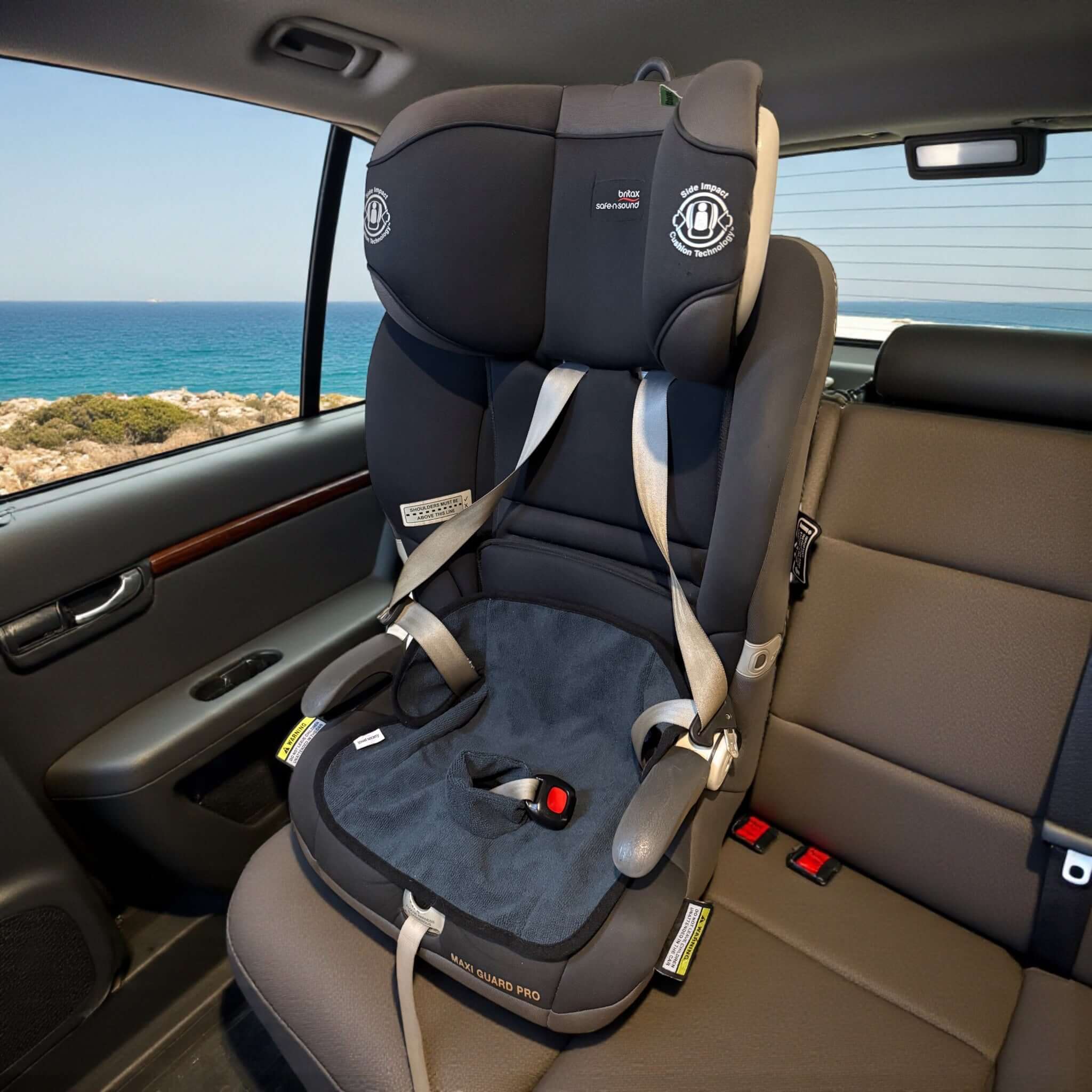 Waterproof child seat towel in charcoal grey installed in a car seat for optimal protection against spills and leaks.