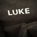 Black car seat towel with LUKE embroidered into headrest