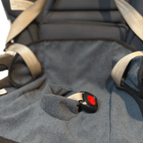 Waterproof child seat towel in charcoal grey with harness buckle in baby car seat