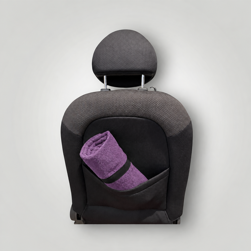 Purple towel stored behind seat
